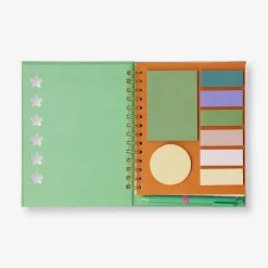Green notebook with ballpoint pen and memos